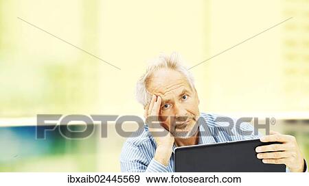"Senior, behind a laptop with a stressed expression" View Large Photo Image Stock Photo - "Senior, behind a laptop with a stressed expression". Fotosearch