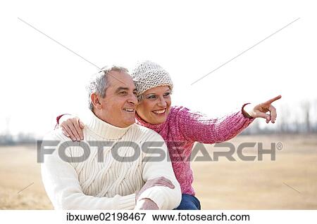 Senior couple looking happily into the distance View Large Photo Image Stock Photo - Senior couple looking happily into the distance. Fotosearch