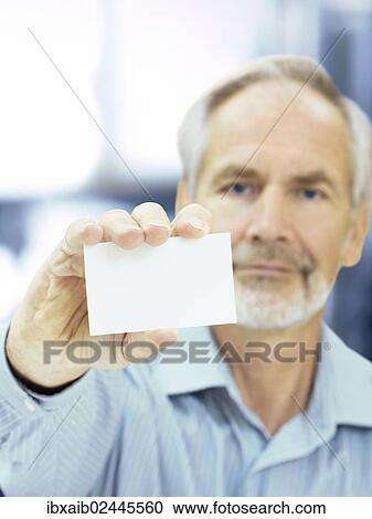 "Senior, holding a blank business card" View Large Photo Image Stock Image - "Senior, holding a blank business card". Fotosearch