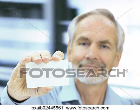 "Senior, holding a blank business card" View Large Photo Image Stock Image - "Senior, holding a blank business card". Fotosearch