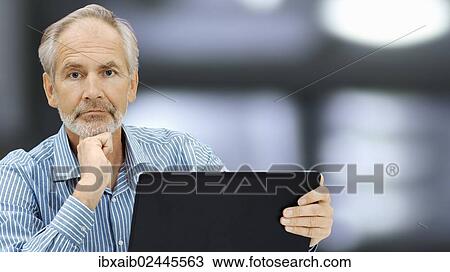 Stock Image - "Senior, with a laptop". Fotosearch