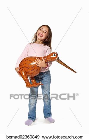 Seven-year-old girl holding an inflatable kiwi View Large Photo Image Stock Photo - Seven-year-old girl holding an inflatable kiwi. Fotosearch