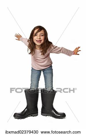 Seven-year-old girl with too big rubber boots View Large Photo Image Stock Image - Seven-year-old girl with too big rubber boots. Fotosearch