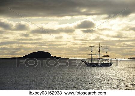 "Ship sailing past an island at sunset, Insel Havsteinen, Alesund, More og Romsdal, Western Norway, Norway, Europe" View Large Photo Image Stock Photo - "Ship sailing past an island at sunset, Insel Havsteinen, Alesund, More og Romsdal, Western Norway, Norway, Europe". Fotosearch