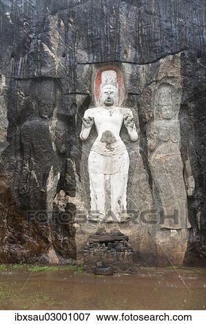 Stock Photo - "Shrine of Mahayana Buddhism, three old Buddha statues as rock reliefs, Avalokiteshvara in white, Tara on the right, Buduruvagala, Wellawaya, Monaragala Distrikt, Sri Lanka, Asia". Fotosearch