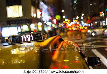 "Sign on the roof of a taxi at night, New York City, USA" View Large Photo Image Picture - "Sign on the roof of a taxi at night, New York City, USA". Fotosearch