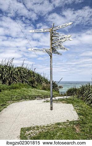 Stock Photography - "Signpost at Far-Away-Point, Tauranga Bay, Cape Foulwind, South Island, New Zealand, Oceania". Fotosearch