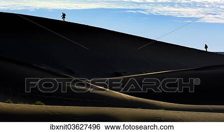"Silhouettes of people climbing a dune, desert landscape, Namib, Hardap Region, Namibia, Africa" View Large Photo Image Stock Photograph - "Silhouettes of people climbing a dune, desert landscape, Namib, Hardap Region, Namibia, Africa". Fotosearch