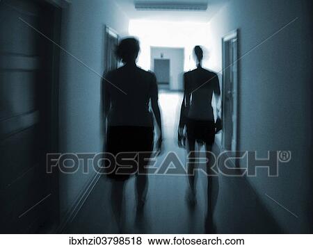 Stock Photo - Silhouettes of two people in a hallway. Fotosearch