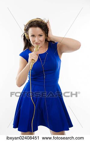 "Singer, woman wearing golden headphones and holding a microphone" View Large Photo Image Stock Image - "Singer, woman wearing golden headphones and holding a microphone". Fotosearch