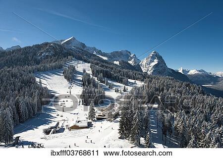 Stock Image - "Skiers on Hausberg Mountain, winter landscape, Garmisch-Partenkirchen, Bavaria, Germany, Europe". Fotosearch