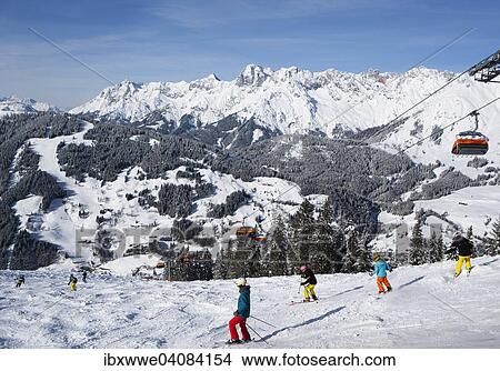 "Skiers on slope in front of mountains, view to the Steinernes Meer, ski resort Ski Amade, Dienten, Salzburg State, Austria, Europe" View Large Photo Image Picture - "Skiers on slope in front of mountains, view to the Steinernes Meer, ski resort Ski Amade, Dienten, Salzburg State, Austria, Europe". Fotosearch