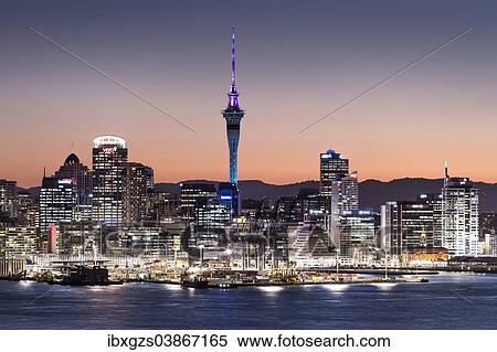 Stock Photography - "Skyline of Auckland with the Sky Tower at dusk, Auckland, North Island, New Zealand, Oceania". Fotosearch