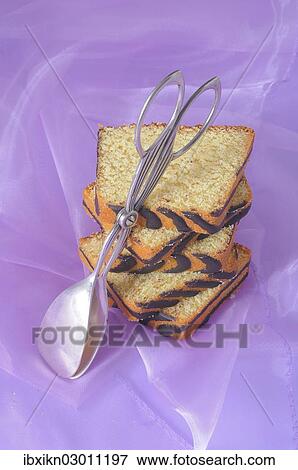 "Slices of ring cake, cake tongs" View Large Photo Image Stock Photo - "Slices of ring cake, cake tongs". Fotosearch