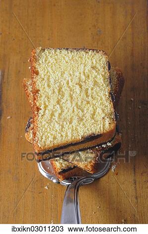 Stock Image - Slices of ring cake on a cake server. Fotosearch