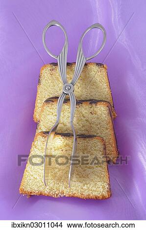 Slices of ring cake with cake tongs View Large Photo Image Picture - Slices of ring cake with cake tongs. Fotosearch