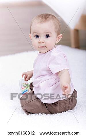 Small baby playing in the living room View Large Photo Image Stock Image - Small baby playing in the living room. Fotosearch