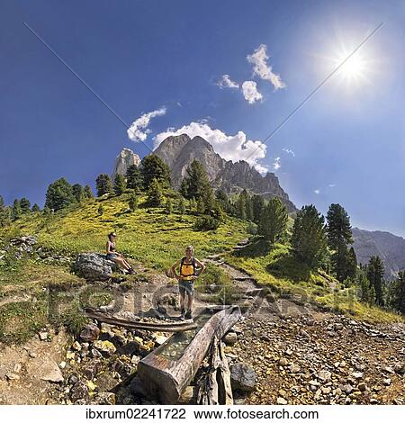 "Small spring at Mt Peitlerkofel, Sasso delle Putia, with hiker at Wuerzjoch, Passo delle Erbe, Villnoess, Funes, Dolomites, South Tyrol, Italy, Europe" View Large Photo Image Stock Image - "Small spring at Mt Peitlerkofel, Sasso delle Putia, with hiker at Wuerzjoch, Passo delle Erbe, Villnoess, Funes, Dolomites, South Tyrol, Italy, Europe". Fotosearch