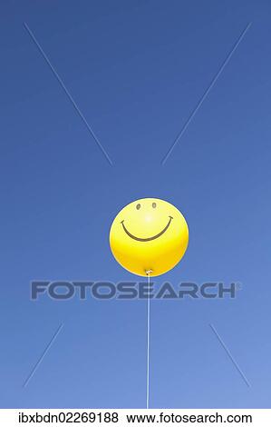 Smiley on balloon against a clear sky View Large Photo Image Stock Photo - Smiley on balloon against a clear sky. Fotosearch