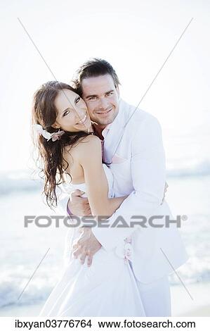Smiling bride and groom by the sea View Large Photo Image Picture - Smiling bride and groom by the sea. Fotosearch