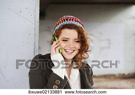 Smiling girl talking on a mobile phone View Large Photo Image Stock Image - Smiling girl talking on a mobile phone. Fotosearch