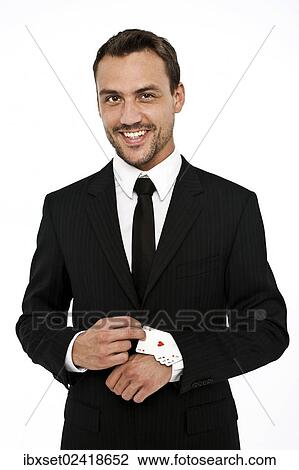 Smiling man wearing a suit pulling several aces out of his sleeve View Large Photo Image Stock Image - Smiling man wearing a suit pulling several aces out of his sleeve. Fotosearch