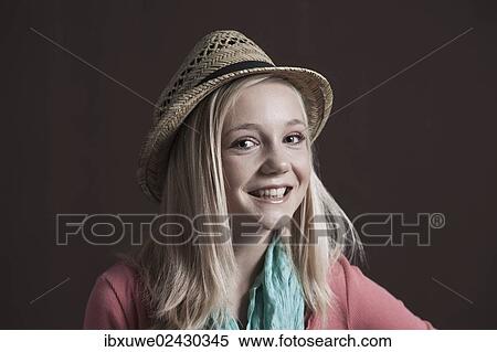 Smiling teenage girl wearing a hat View Large Photo Image Stock Photography - Smiling teenage girl wearing a hat. Fotosearch