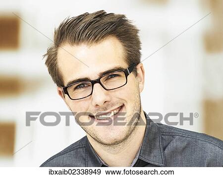 "Smiling young businessman wearing glasses, portrait" View Large Photo Image Stock Photo - "Smiling young businessman wearing glasses, portrait". Fotosearch