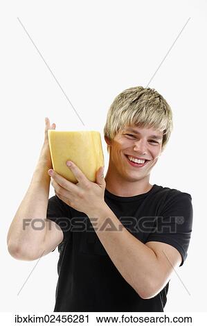 Smiling young man carrying half a wheel of cheese on his shoulder View Large Photo Image Stock Image - Smiling young man carrying half a wheel of cheese on his shoulder. Fotosearch
