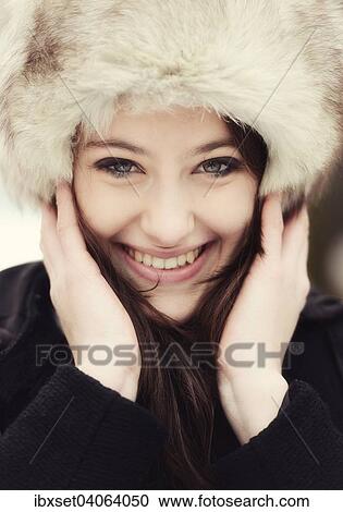 "Smiling young woman wearing a fur hat, portrait" View Large Photo Image Stock Image - "Smiling young woman wearing a fur hat, portrait". Fotosearch