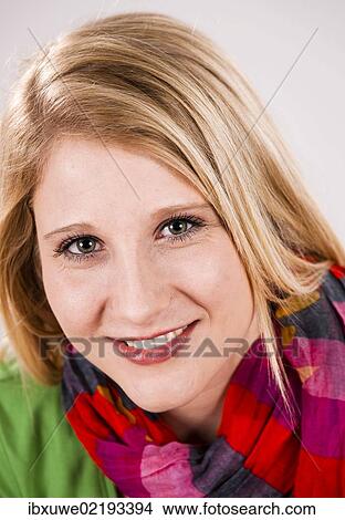 Picture - "Smiling young woman wearing a scarf, portrait". Fotosearch