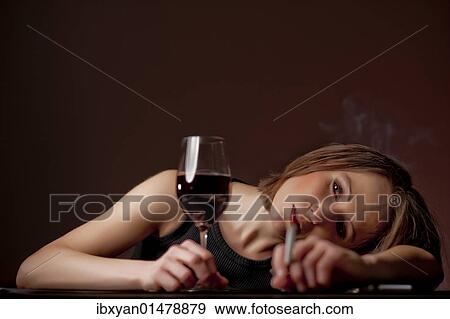 Stock Photo - Smoking woman with a glass of wine. Fotosearch