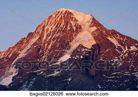 "Snow and ice covered summit of Moench Mountain in evening light, view from the west, Muerren, Bernese Oberland, Switzerland, Europe" View Large Photo Image Stock Photograph - "Snow and ice covered summit of Moench Mountain in evening light, view from the west, Muerren, Bernese Oberland, Switzerland, Europe". Fotosearch