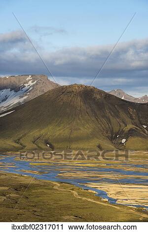 Stock Image - "Snow-capped rhyolite mountains, Joekulgilskvisl river, Landmannalaugar Fjallabak Nature Reserve, Highlands, Iceland, Europe". Fotosearch