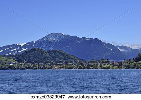 "Snow-covered Grunten Mountain behind Alpsee lake, Upper Allgau, Bavaria, Germany, Europe" View Large Photo Image Stock Photo - "Snow-covered Grunten Mountain behind Alpsee lake, Upper Allgau, Bavaria, Germany, Europe". Fotosearch