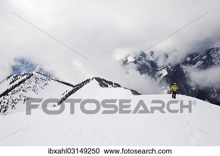Stock Image - "Snowshoe hiker on the summit ridge of Schoenalmjoch in the Karwendel Mountains, Karwendel Mountains, Hinterriss, Tyrol, Austria, Europe". Fotosearch