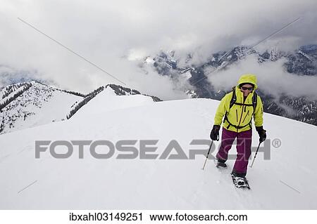 Stock Image - "Snowshoe hiker on the summit ridge of Schoenalmjoch in the Karwendel Mountains, Karwendel Mountains, Hinterriss, Tyrol, Austria, Europe". Fotosearch