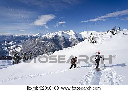 "Snowshoe walkers during the ascent of the Mt Morgenrast summit from Unterreinswald, Sartntal valley and its mountains at back, South Tyrol, Italy, Europe" View Large Photo Image Stock Photo - "Snowshoe walkers during the ascent of the Mt Morgenrast summit from Unterreinswald, Sartntal valley and its mountains at back, South Tyrol, Italy, Europe". Fotosearch