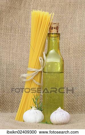 Spaghetti and a bottle of oil View Large Photo Image Stock Image - Spaghetti and a bottle of oil. Fotosearch