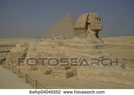 Stock Image - "Sphinx or Great Sphinx of Giza, lion with a human head, built in the 4th Egyptian dynasty around 2700 BC, in front of the Pyramid of Cheops, Giza, Egypt, Africa". Fotosearch