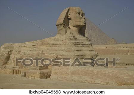 Stock Image - "Sphinx or Great Sphinx of Giza, lion with a human head, built in the 4th Egyptian dynasty around 2700 BC, in front of the Pyramid of Cheops, Giza, Egypt, Africa". Fotosearch