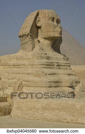 Stock Image - "Sphinx or Great Sphinx of Giza, lion with a human head, built in the 4th Egyptian dynasty around 2700 BC, in front of the Pyramid of Cheops, Giza, Egypt, Africa". Fotosearch