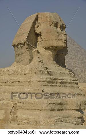 Stock Image - "Sphinx or Great Sphinx of Giza, lion with a human head, built in the 4th Egyptian dynasty around 2700 BC, in front of the Pyramid of Cheops, Giza, Egypt, Africa". Fotosearch