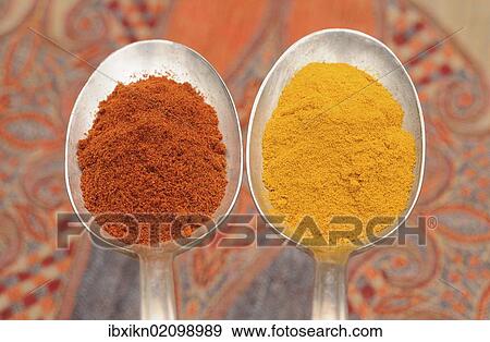Stock Photo - "Spices on old spoons, paprika and curry powder". Fotosearch
