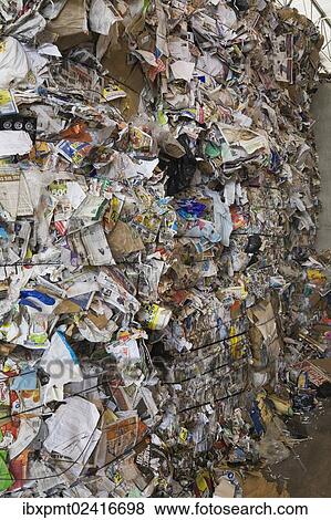 Stock Photo - "Stacked bales of recyclable cardboard and paper at a sorting centre, Quebec, Canada, North America". Fotosearch
