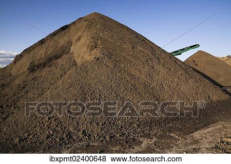 Stock Photo - "Stacking conveyor and mounds of sand in a commercial sandpit, Quebec, Canada, North America". Fotosearch
