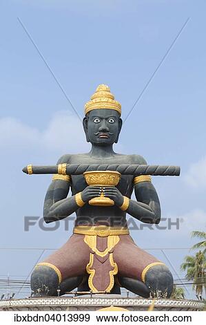 Stock Photo - "Statue of Ta Dambong with his magic stick, symbol of the city of Battambang, Cambodia, Asia". Fotosearch