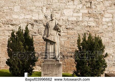 Stock Image - "Statue of the preacher Thomas Muntzer in front of the city walls of Muhlhausen, Unstrut Hainich district, Thuringia, Germany, Europe". Fotosearch