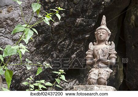 Stock Image - "Statue or sculpture in front of the Buddha Cave, Mae Cham, Chiang Rai Province, Northern Thailand, Thailand, Asia". Fotosearch