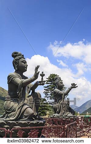 "Statues of Devas making offerings at Tian Tan Buddha image at Po Lin Monastery, Lantau Island, Hong Kong, China, Asia" View Large Photo Image Stock Image - "Statues of Devas making offerings at Tian Tan Buddha image at Po Lin Monastery, Lantau Island, Hong Kong, China, Asia". Fotosearch